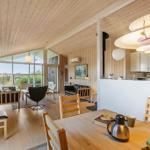 Living and dining area with wood paneling and modern lighting.