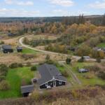 House with garden and forest in autumn