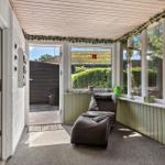 Terrace with seating and view of garden.