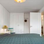 Bedroom with bed, wardrobe, and lamps