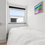 Bedroom with bed, window, and wall art.