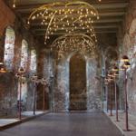 Großer Raum mit Backsteinwänden, modernen Lampen und goldenen Deckenleuchten.