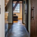 Hallenflur mit Holzboden und Blick in Schlafzimmer mit Fenster