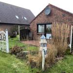 Red brick building with garden, terrace, and satellite dish.