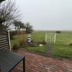 Terrace with view of green garden and white garden gate