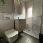 Bathroom with shower, sink and toilet.