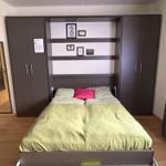 Bedroom with bed, wardrobe, and mirror