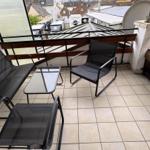 Terrace with seating group and view of rooftops