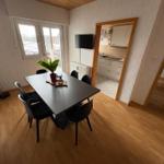 Dining area with table, chairs, and window to terrace