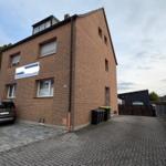 Two-story brick house with garage and front yard. House number 25.
