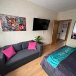 Room with sofa, bed, and wall art of a tiger.