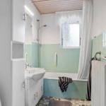 Bathroom with bathtub, shower, sink, and toilet.