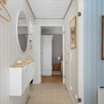Hallway with mirror, cabinet, and door to bedroom