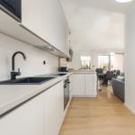 Modern kitchen with worktop and view into living area