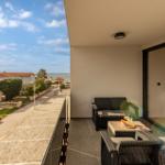 Terrace with seating and view of street and sea