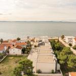 Sea view of houses and green areas along the coast.