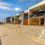 Modern vacation homes with terraces and parking spaces by the coast.