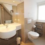 Moderne Einrichtung, großer Spiegel und genügend Ablagefläche für Kosmetik finden Sie im Badezimmer zu Genüge