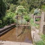 Außenliegender Whirlpool mit Metallgeländer und umgebendem Garten.