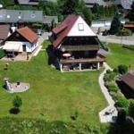 House with balcony, large garden, and view of wind turbines