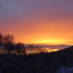 Winter sunset with snow-covered trees and colorful sky