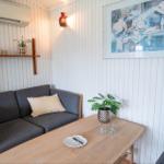 A living area with sofa, table, and wall art.