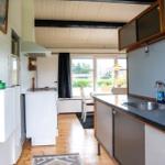 Kitchen with countertop, sink, and window view