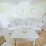 Wohnzimmer mit Sofa, Tisch und Stehlampe.
