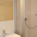 Bad mit Dusche, Waschbecken und Spiegel