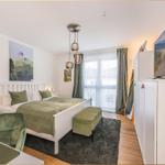 Schlafzimmer mit Bett, TV und Fenster