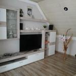 Living room with TV, cabinet, and armchair