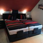 Bedroom with double bed, nightstands, and wall art