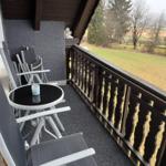 Deck with table and chairs, view of green field
