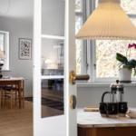 Kitchen with table, lamp, and plant. Through window and door to living room.