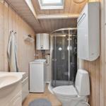 Bathroom with shower, toilet, and washing machine.