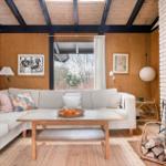 Living room with sofa, fireplace, and wooden floor.