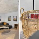 Wohnzimmer mit Sofa, Couchtisch und Wandbildern. Magazine in einem Korb.