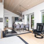 Living and dining area with dining table, sofa, recliner, and kitchen.