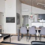 Living and dining area with table, chairs, and modern lighting.