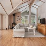 Living room with wooden ceiling, sofa, fireplace, and TV.