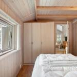 Bedroom with bed, wardrobe, and window with view.