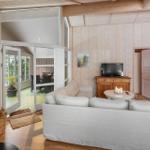 Living room with sofa, fireplace, and glass door to terrace