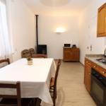 Kitchen with dining area, wooden furniture, and gas stove