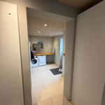 Laundry room with washing machine, dryer, and work surface.