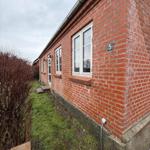 Red brick building with windows and house number 5 on the facade.