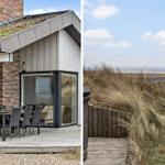 Moderne Strandvilla mit Terrasse und Meerblick durch Dünen.