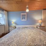 Bedroom with bed, nightstands, and window.