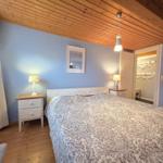 Bedroom with double bed, nightstands, and closet.