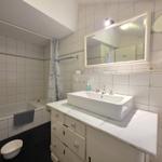 Bathroom with bathtub, sink, and mirror