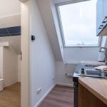 Küche mit Fenster und angrenzender Toilettenstube.